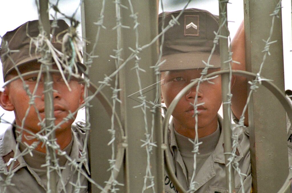 GUARDING BEHIND THE FENCE