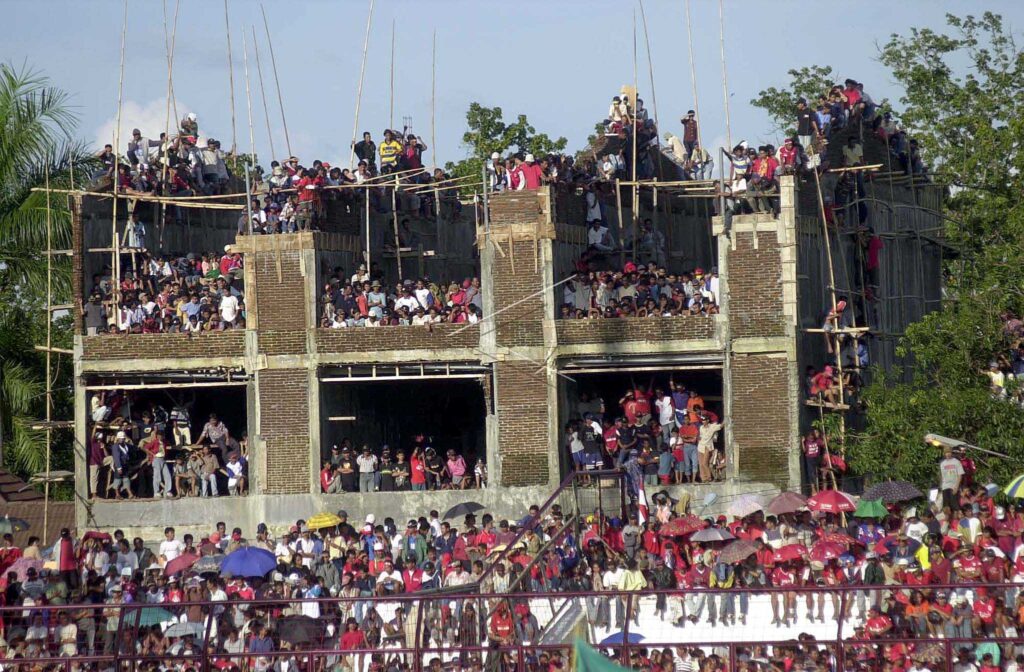 WATCHING SOCCER MATCH FROM THE UNFINISHED RESIDENTIAL HOUSE