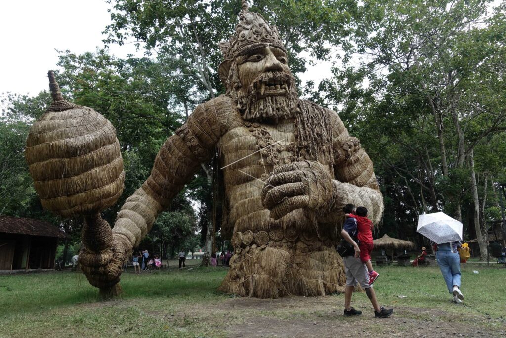 THE GIANT STRAW STATUE AT PRAMBANAN TEMPLE COMPLEX